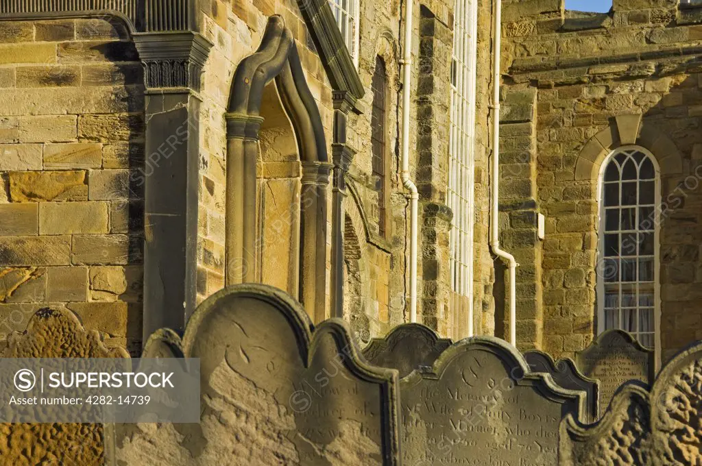 England, North Yorkshire, Whitby. Weathered gravestones in the graveyard of St Mary's church, the parish church of Whitby on top of the hill overlooking the harbour.