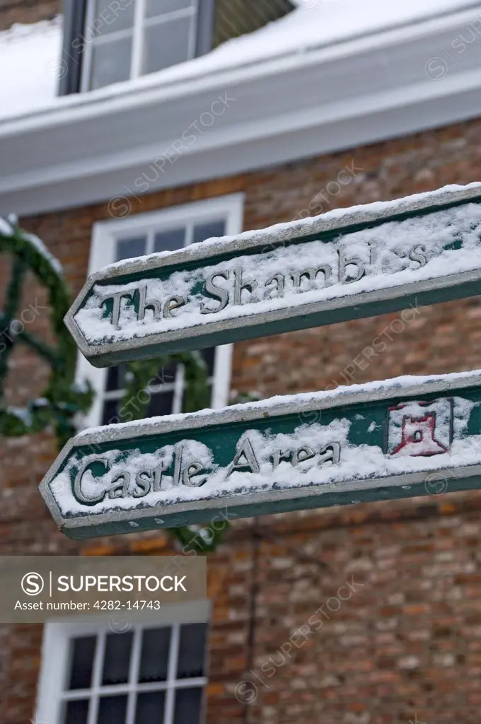 England, North Yorkshire, York. Snow on a tourist information sign with directions to The Shambles and Castle Area in York.