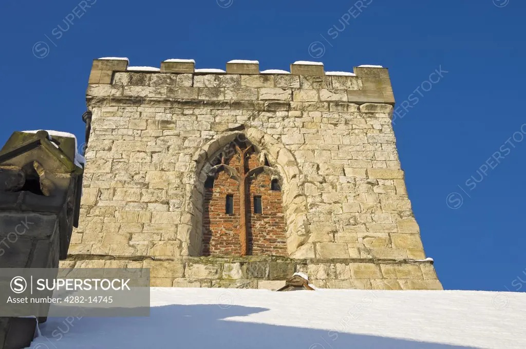 England, North Yorkshire, York. A winter view looking up at the tower of Holy Trinity Church off Goodramgate in York.