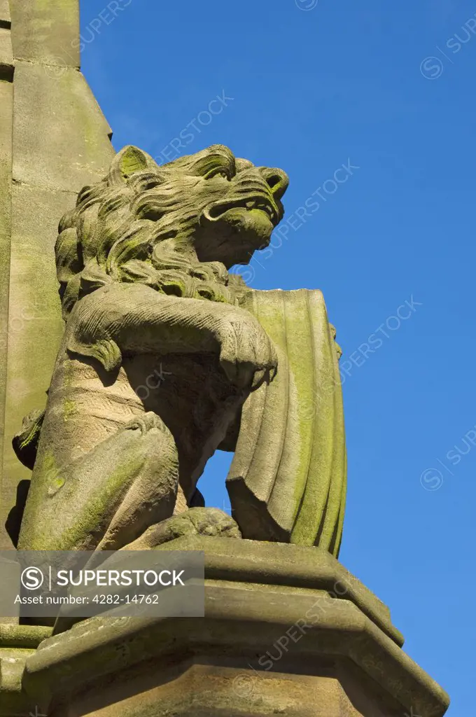 England, North Yorkshire, Harrogate. Lion at the base of Queen Victoria Statue in Station Square.