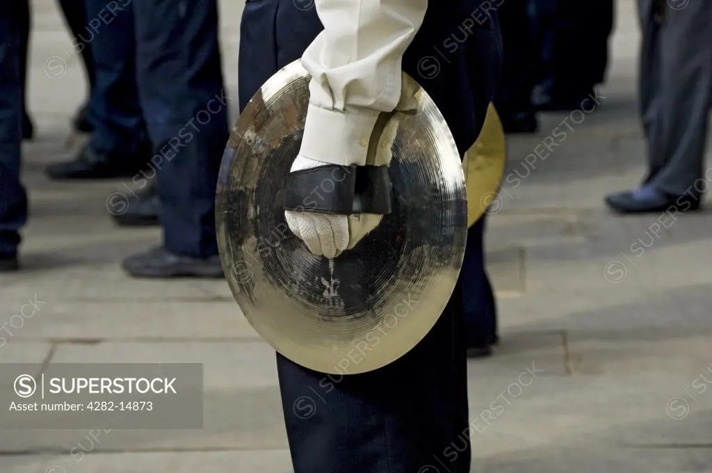 England, North Yorkshire, York. Member of the Scout band holding a cymbal in the annual Saint George's Day parade.