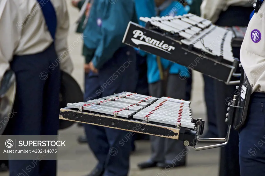 England, North Yorkshire, York. Close up of glockenspiel player in the Scout band taking part in the annual Saint George's Day parade.