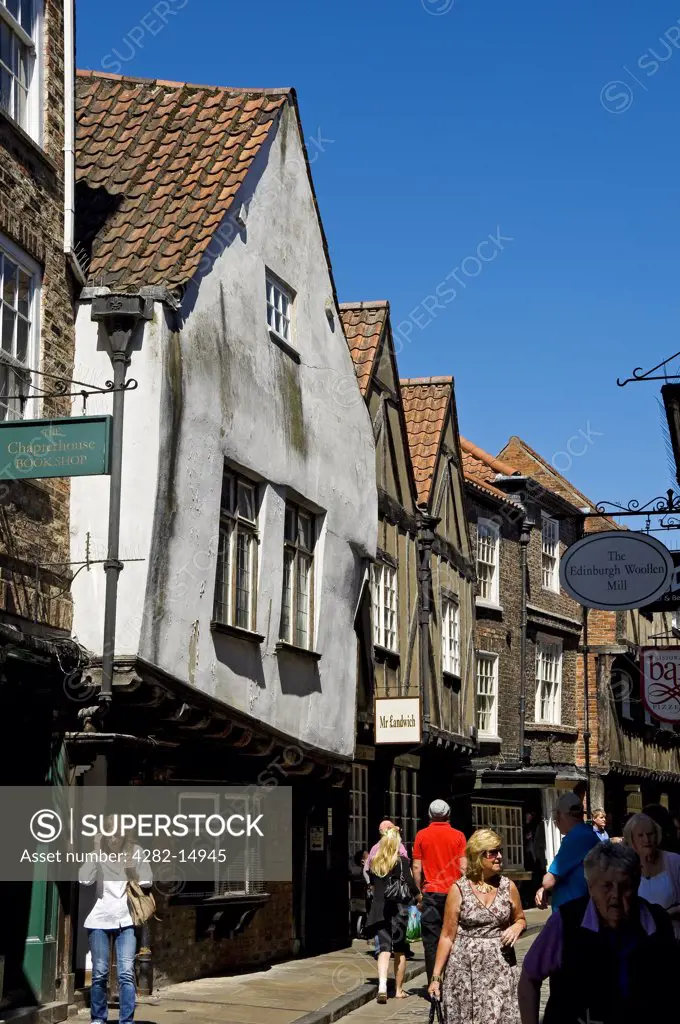 England, North Yorkshire, York. Tourists walking along Shambles, York's famous medieval street.