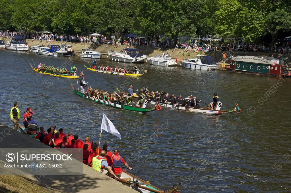 England, North Yorkshire, York. Boats competing in the Dragon Boat Challenge on the River Ouse.
