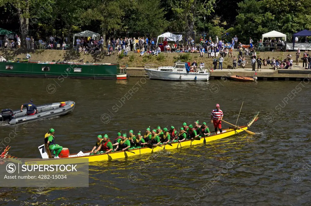 England, North Yorkshire, York. Boat competing in the Dragon Boat Challenge on the River Ouse.