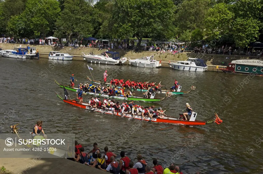 England, North Yorkshire, York. Boats competing in the Dragon Boat Challenge on the River Ouse.