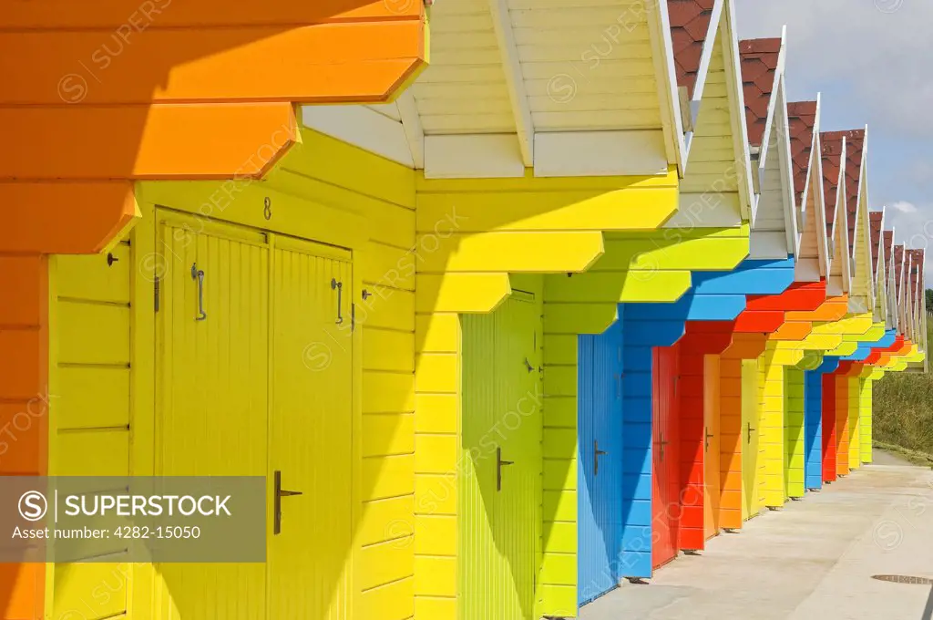 England, North Yorkshire, Scarborough. A row of colourful beach huts at North Bay.