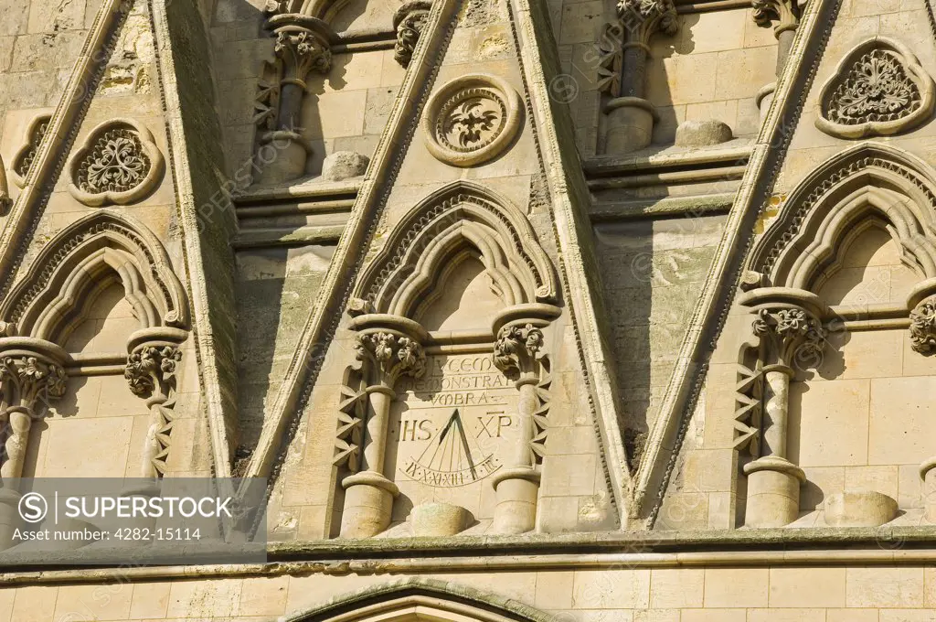 England, North Yorkshire, York. A sun dial on a wall above the door of the South Transept of York Minster.
