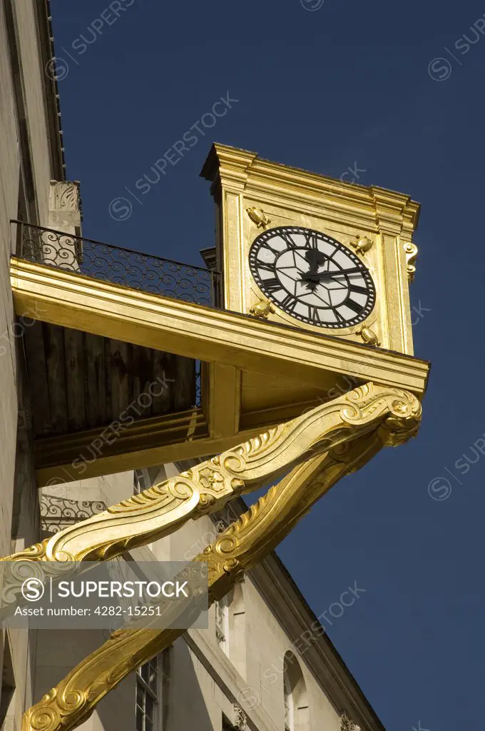 England, West Yorkshire, Leeds. Golden clock on Leeds Civic Hall in Millennium Square.