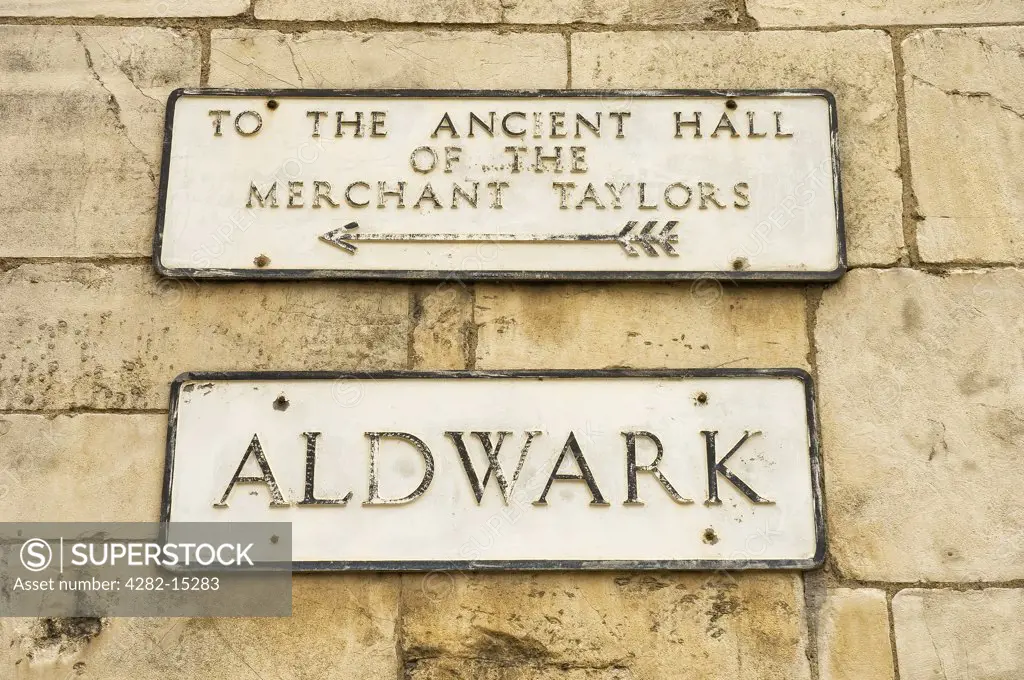 England, North Yorkshire, York. Street sign pointing to the Ancient Hall of the Merchant Taylors at Aldwark.