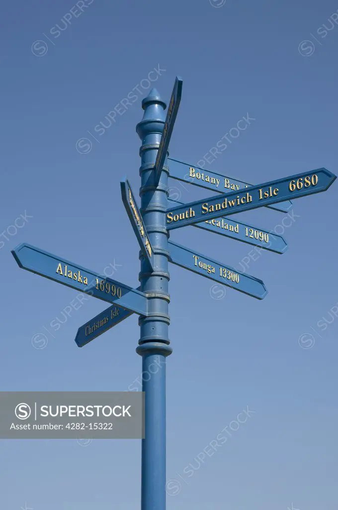 England, North Yorkshire, Whitby. A signpost showing distances and directions from Whitby of Captain Cook's voyages.