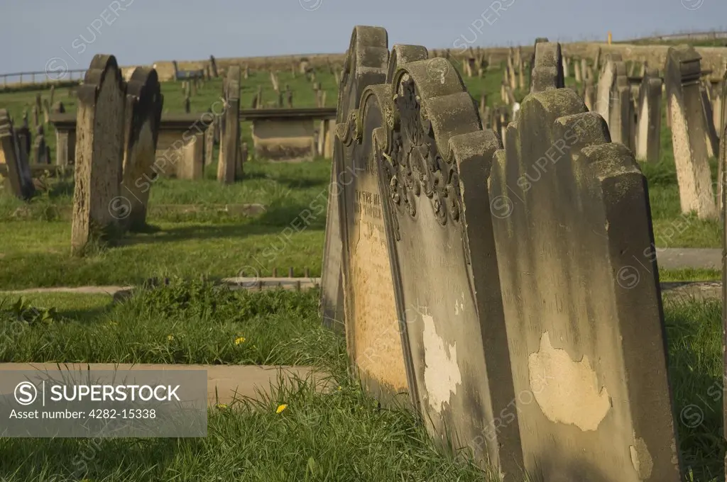 England, North Yorkshire, Whitby. Weathered headstones in St Mary's churchyard.