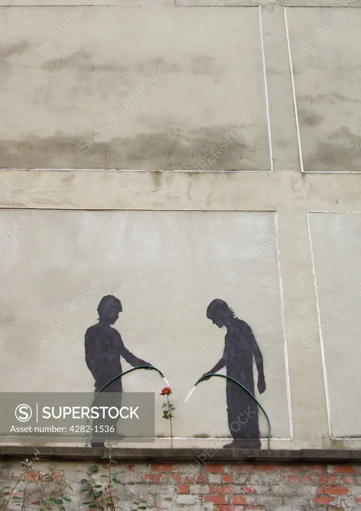 England, Tyne and Wear, Newcastle Upon Tyne. Urban art of two children watering a flower.