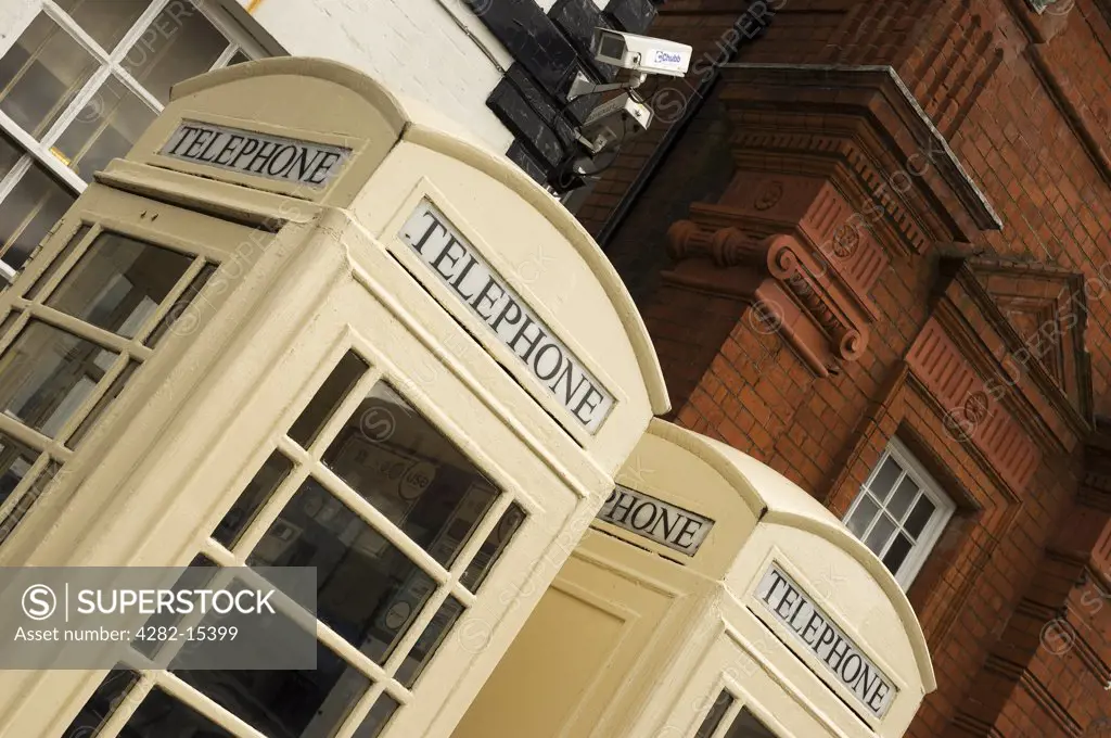England, East Riding of Yorkshire, Beverley. Two cream public telephone boxes in the Saturday Market at Beverley.