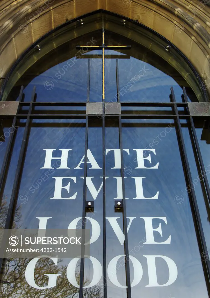 England, Tyne and Wear, Newcastle Upon Tyne. The words Hate Evil Love Good on the entrance to St. Thomas the Martyr church.