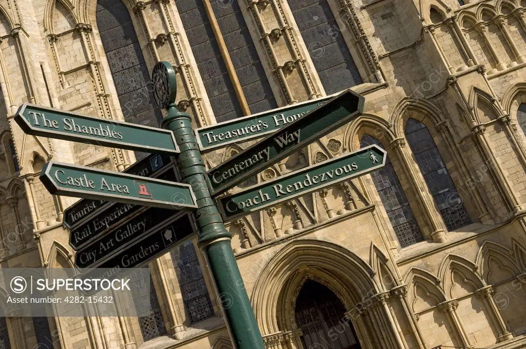 England, North Yorkshire, York. Tourist information signpost with York Minster in the background.