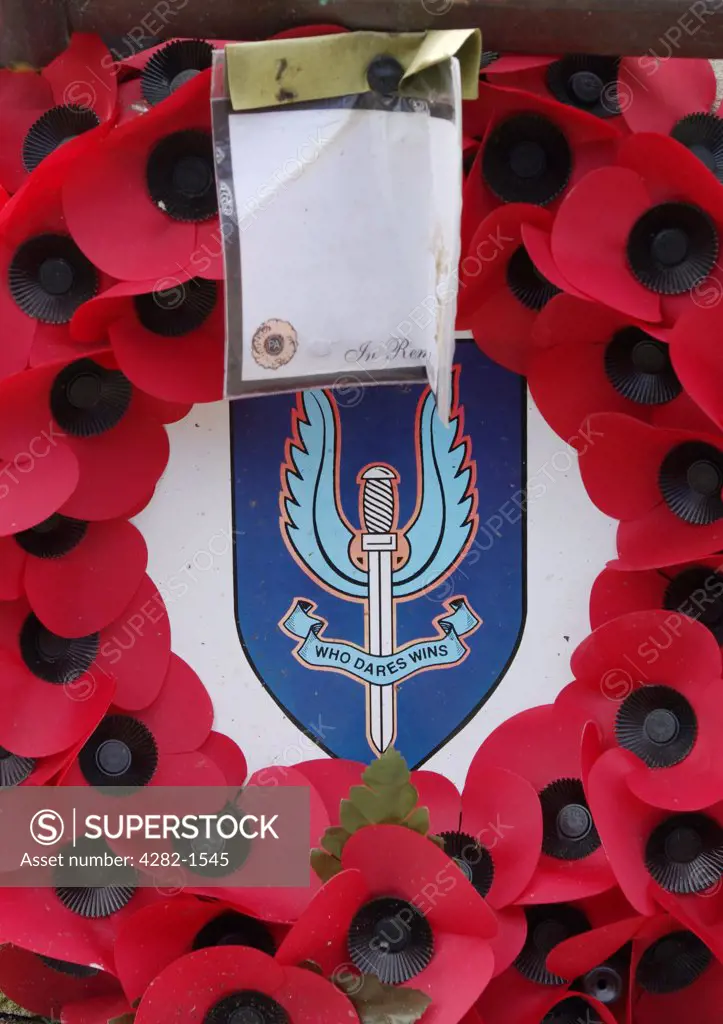 England, Tyne and Wear, Newcastle Upon Tyne. War memorial wreath of poppies with Who Dares Wins emblem.