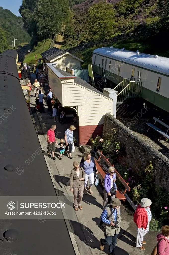 England, North Yorkshire, Goathland. Passengers disembarking from a train at Goathland railway station on the North Yorkshire Moors Railway.