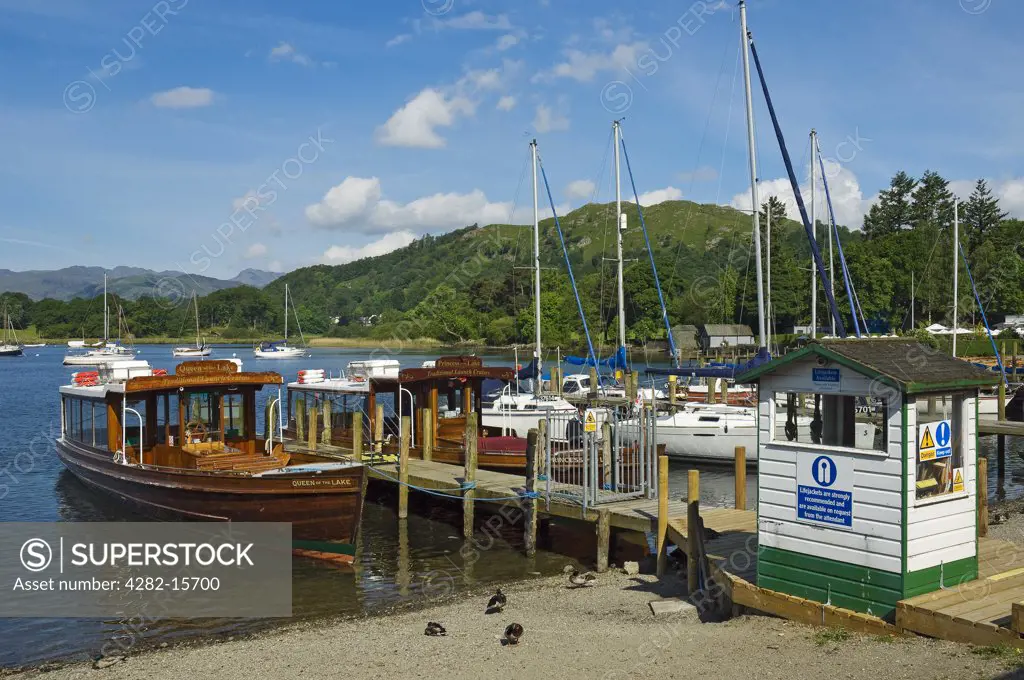 England, Cumbria, Ambleside. The Queen of the Lake pleasure boat tied to a jetty on the shore of Lake Windermere at Ambleside.