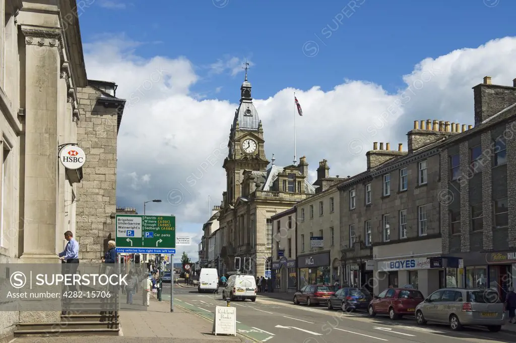 England, Cumbria, Kendal. A view along Highgate in Kendal, past shops and banks towards the Town hall.
