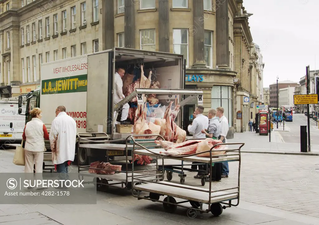 England, Tyne & Wear, Newcastle Upon Tyne. Butcher's unloading meat from a van in Newcastle city centre.
