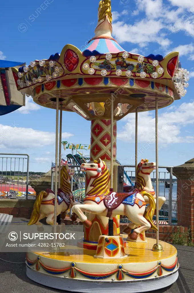 England, East Riding of Yorkshire, Bridlington. A small carousel for young children at the amusements in Bridlington.
