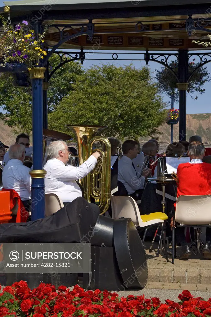 England, North Yorkshire, Filey. A brass band playing in the bandstand in Crescent Gardens.