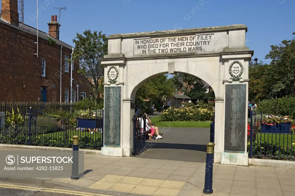 England, North Yorkshire, Filey. The War Memorial Arch and Garden in Filey. The arch is inscribed with the words ""IN HONOUR OF THE MEN OF FILEY WHO DIED FOR THEIR COUNTRY IN THE TWO WORLD WARS.""