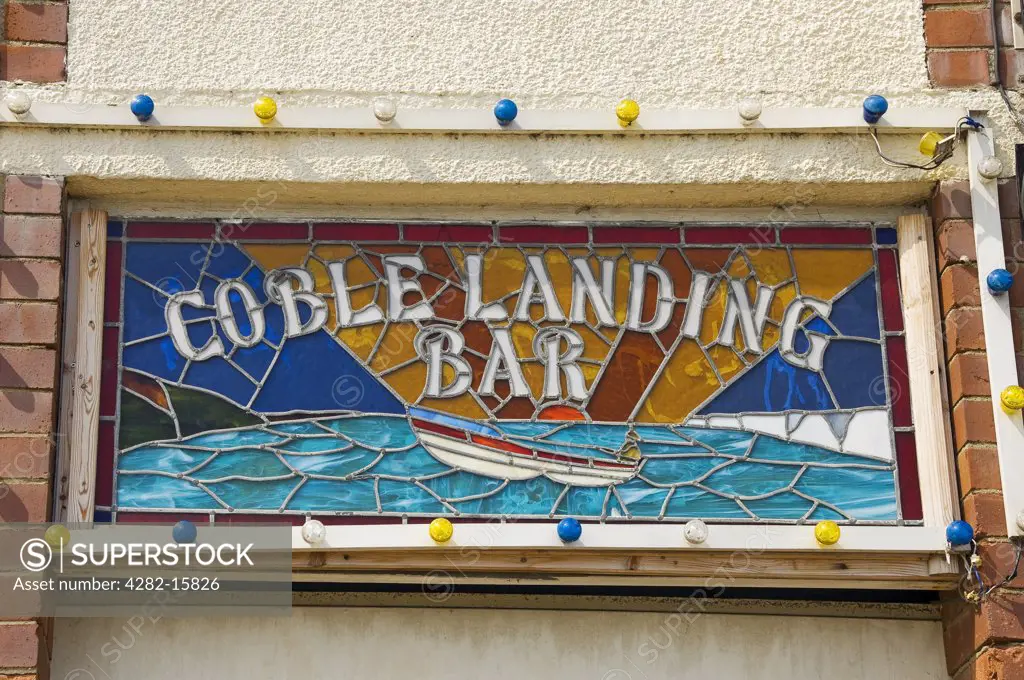 England, North Yorkshire, Filey. Stained glass sign for the Coble Landing Bar in Filey.