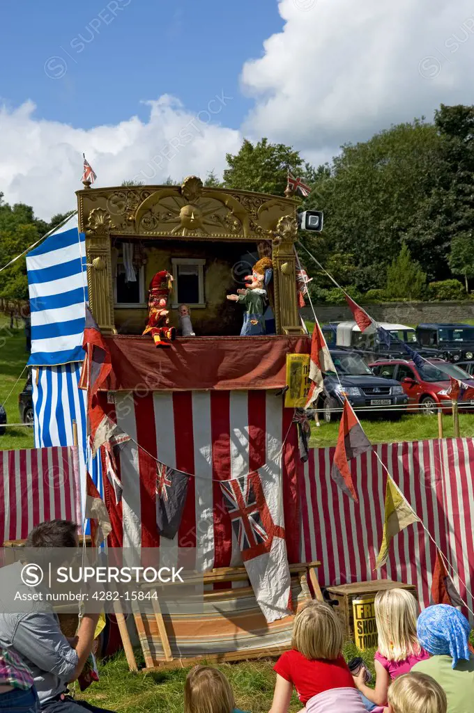 England, North Yorkshire, Gargrave. Young children enjoying a Punch and Judy at Gargrave Show, an annual country show near Skipton.