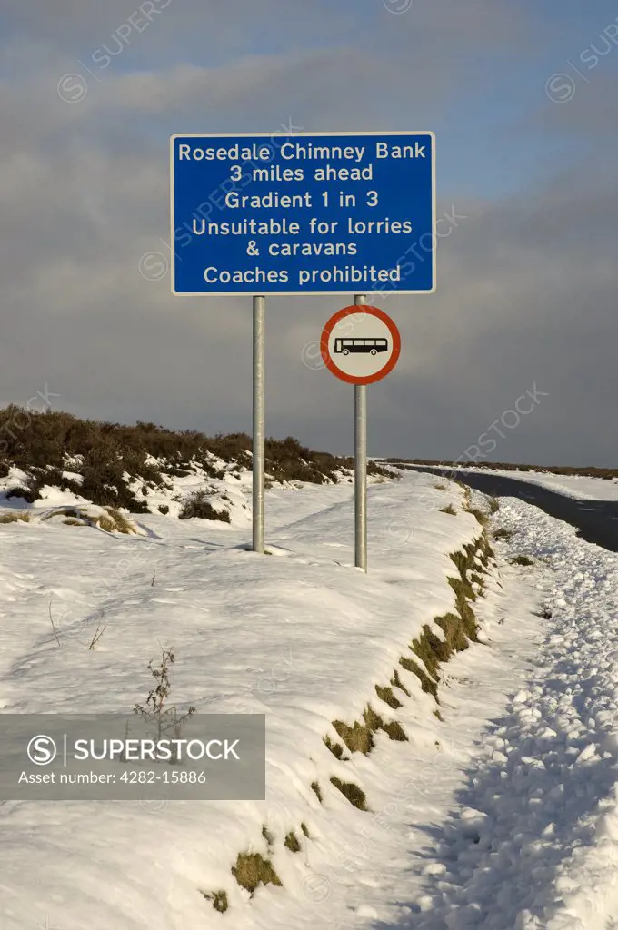 England, North Yorkshire, North York Moors. A warning sign beside the road to Rosedale Chimney Bank in winter.