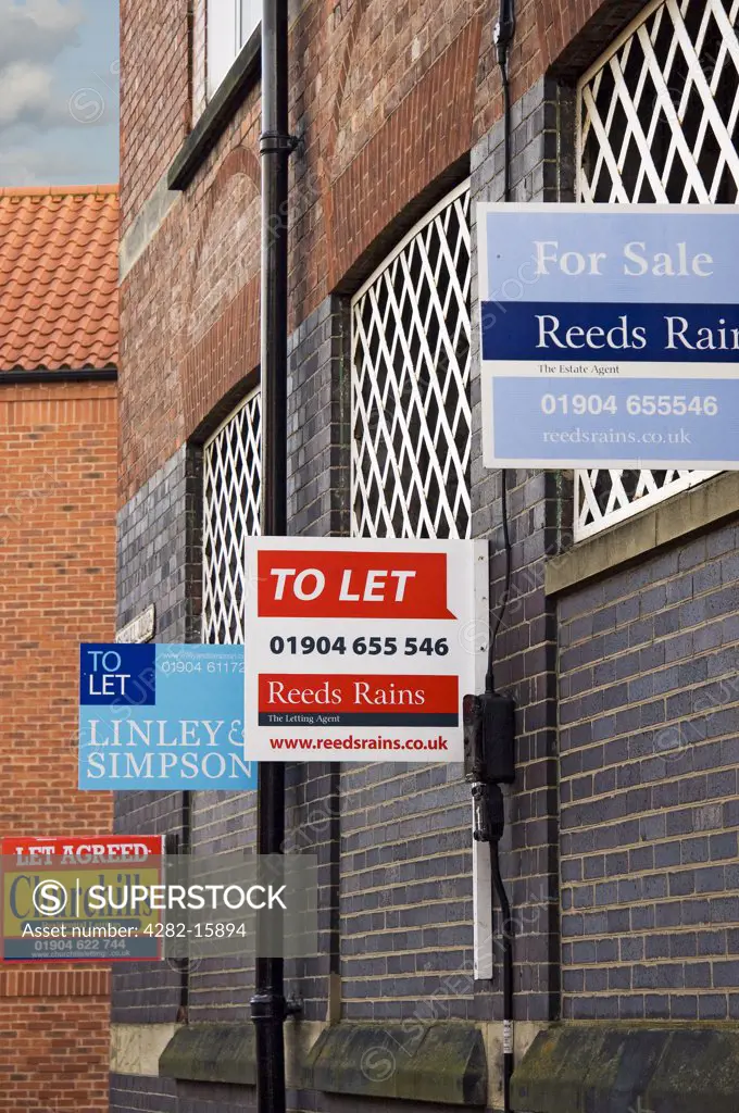 England, North Yorkshire, York.  A row of residential property sign boards outside homes in York.