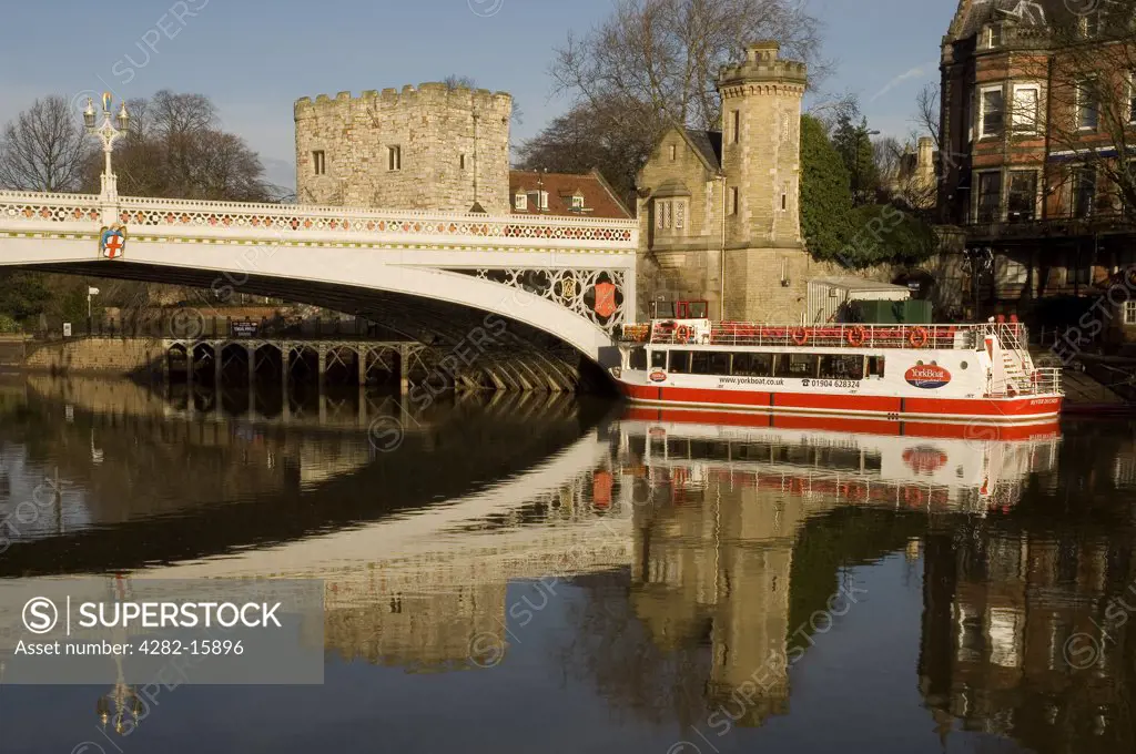 England, North Yorkshire, York. Lendal Bridge and a pleasure boat on River Ouse in York.