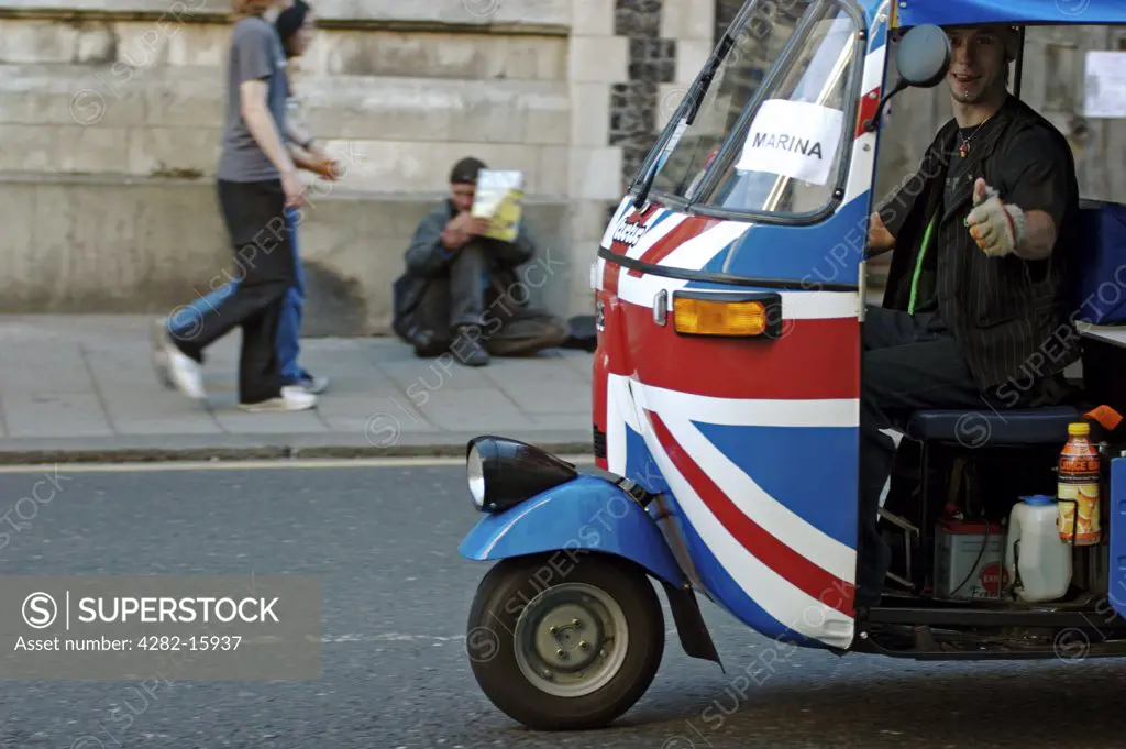 England, East Sussex, Brighton. Tuk tuk painted with Union Jack. The tuk-tuk is the Southeast Asian version of a vehicle known elsewhere as an auto rickshaw or cabin cycle.