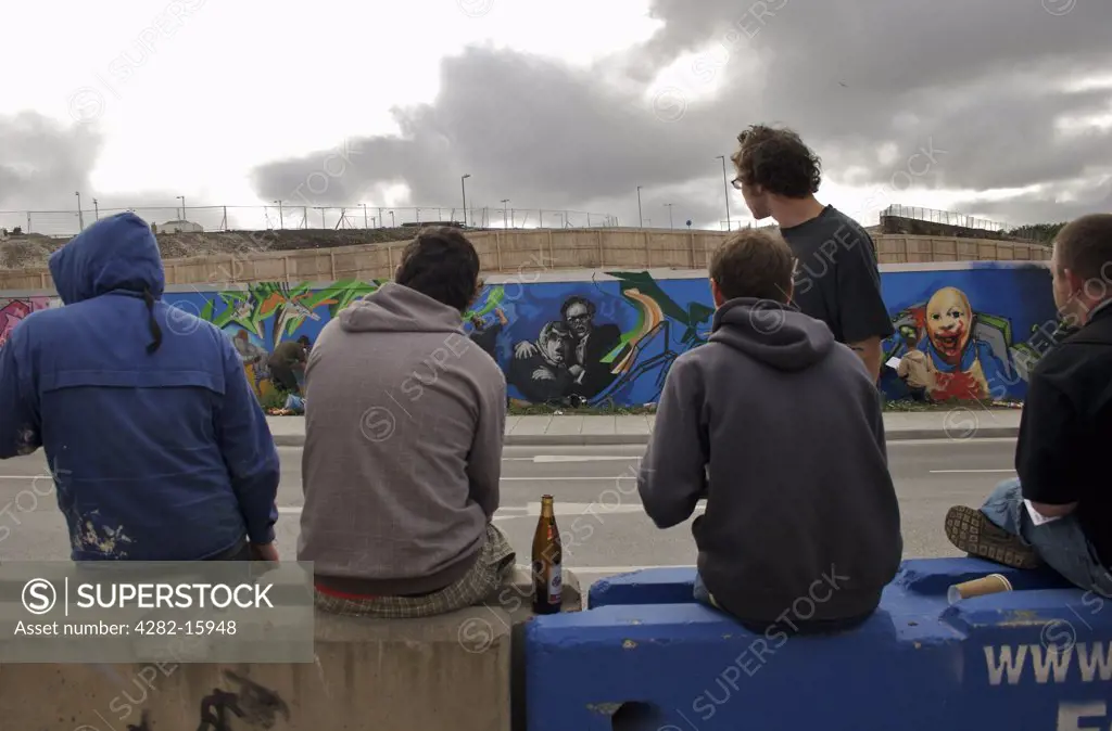 England, East Sussex, Brighton. Graffiti artists take a break. The word 'graffiti' is the plural of 'graffito' and originates from the Italian word 'graffiato' which means scratched.