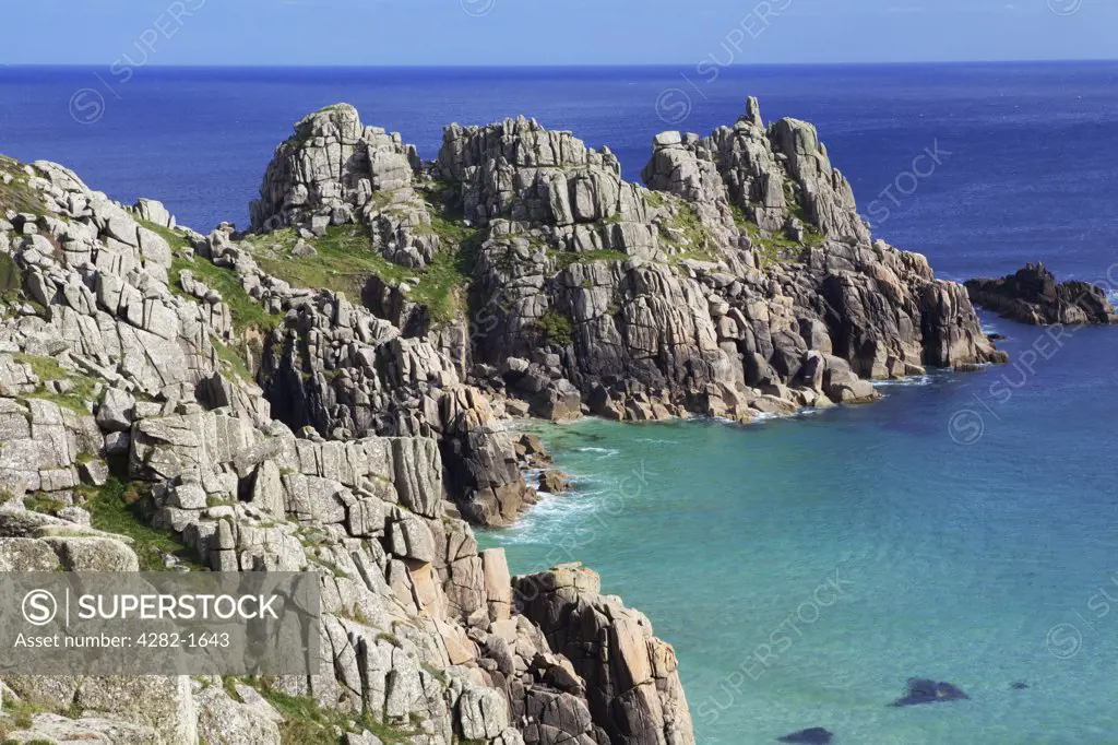 England, Cornwall, Porthcurno. Logan Rock viewed from Treen cliffs. The cliffs and coastline around Porthcurno are officially designated Areas of Outstanding Natural Beauty.