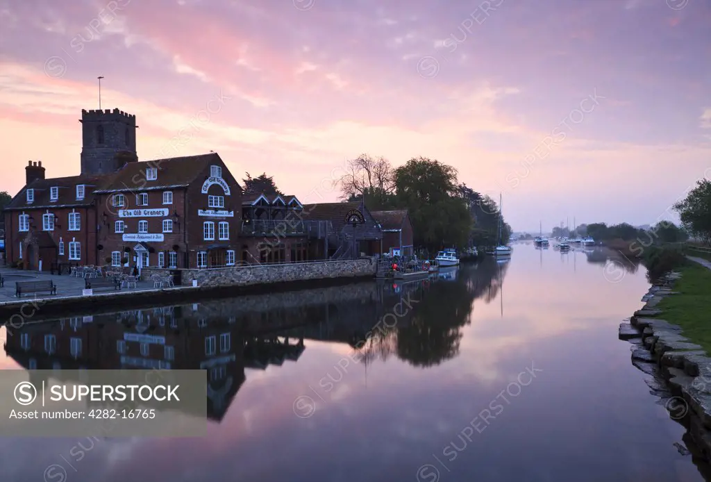 England, Dorset, Wareham Quay. Dawn over The Old Granary, Riverside Restaurant and Bar by the River Frome at Wareham Quay.