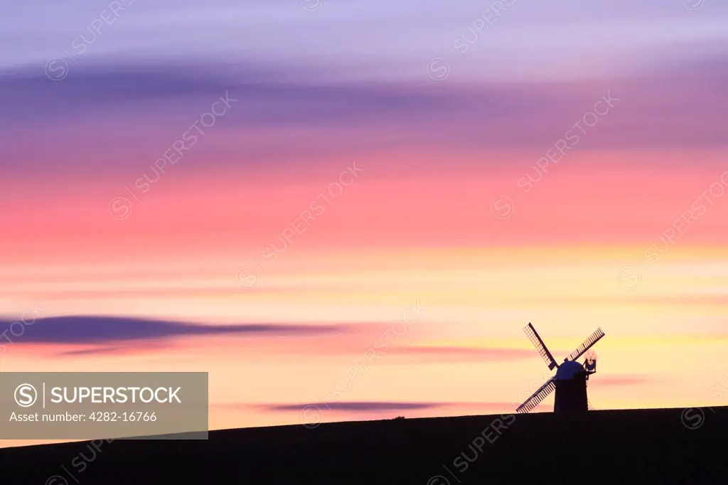 England, Wiltshire, Wilton. Wilton Windmill, near Marlborough, silhouetted against the sunset. The mill is the only working windmill in Wessex and was originally constructed in 1821 after the new Kennet and Avon canal had been built.