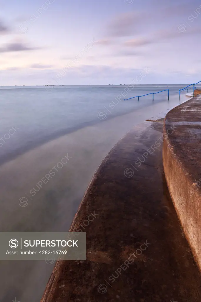 Channel Islands, Jersey, St Helier. Havre des Pas bathing pool, a Victorian, tidal, sea water swimming pool at dawn.
