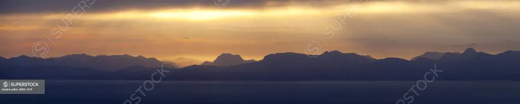 Scotland, Isle of Skye, Trotternish. A panoramic view at sunrise from the Quiraing towards the distant hills on the mainland.