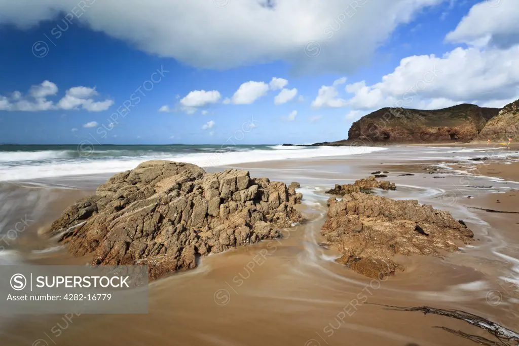 Channel Islands, Jersey, Plemont Bay. Swirling tide around rocks on the sandy beach at Plemont Bay in Jersey.