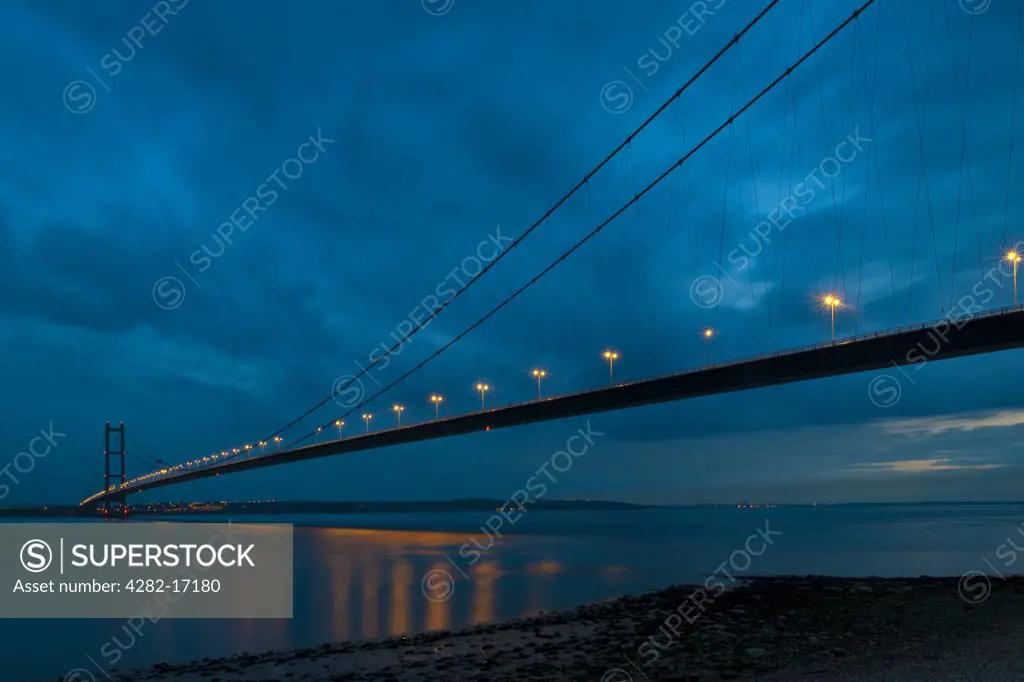 England, East Riding of Yorkshire, Hessle. The Humber Bridge spanning the Humber Estuary at dusk. The bridge is the fifth largest single-span suspension bridge in the world.