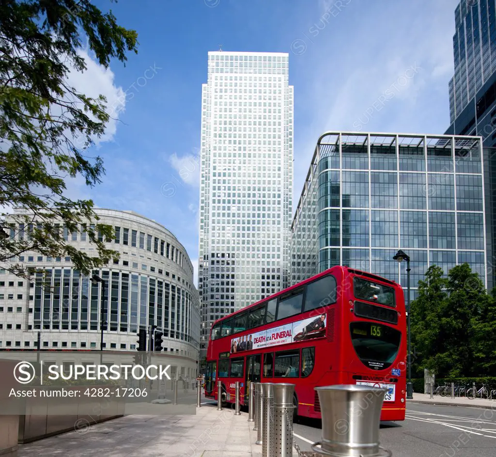 England, London, Canary Wharf. A red London double decker bus and One Canada Square, the tallest completed building in the UK.