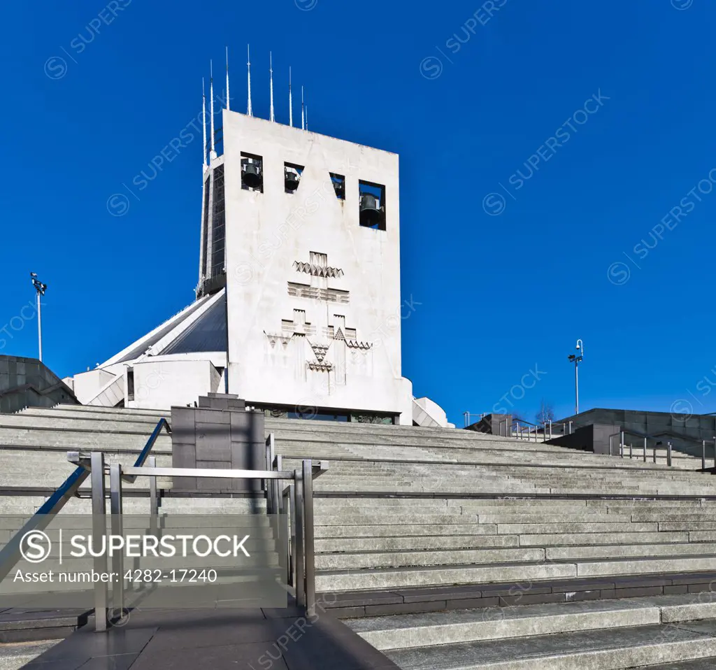 England, Merseyside, Liverpool. External view of The Metropolitan Cathedral Church of Christ the King known as Liverpool Metropolitan Cathedral, showing the four bells, Matthew, Mark, Luke and John, over the entrance portico.
