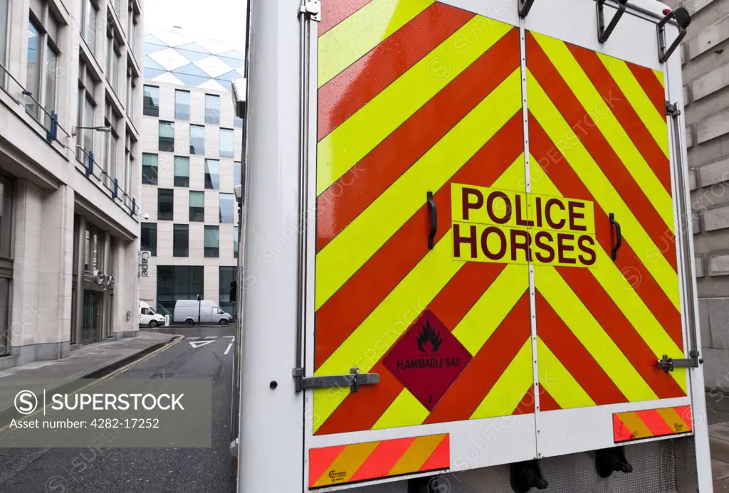 England, London, City of London. Rear of Police Horesebox with yellow and red chevrons, outside Wood Street Police Station.