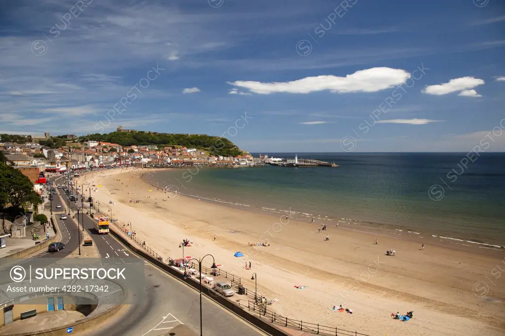 England, North Yorkshire, Scarborough. People relaxing on the South Bay beach at Scarborough.