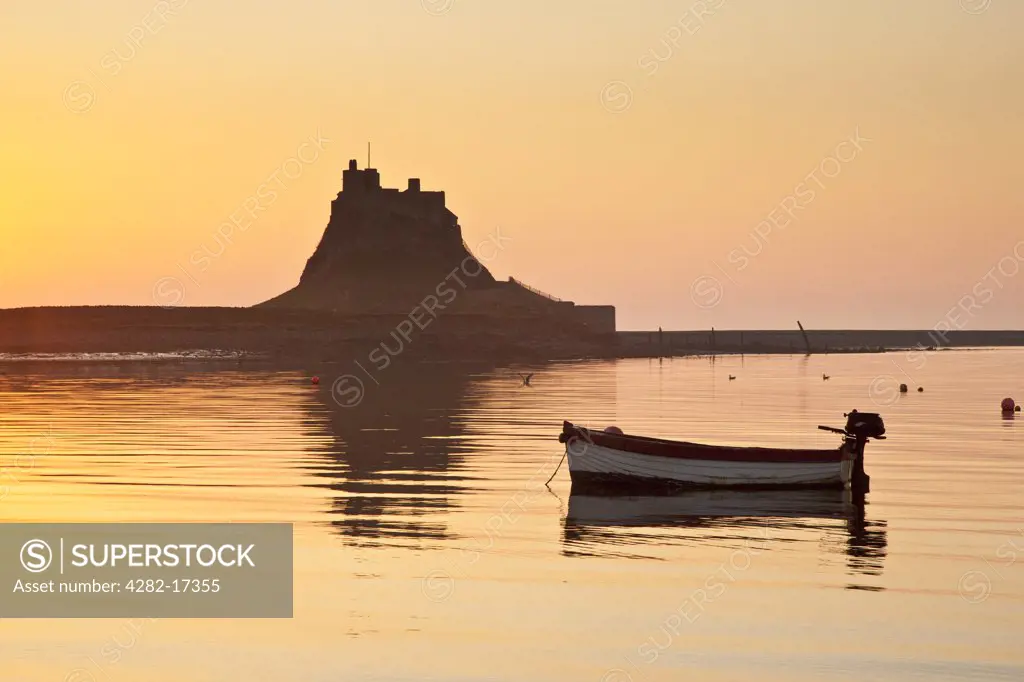 England, Northumberland, Holy Island. A small boat moored by Lindisfarne Castle at dawn.
