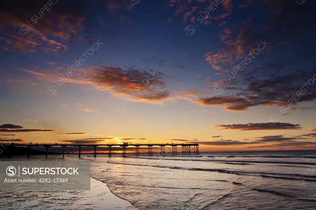 England, Redcar & Cleveland, Saltburn-By-The-Sea. Sunset over the Victorian pier at Saltburn-By-The-Sea, the first and last on the North East coast.