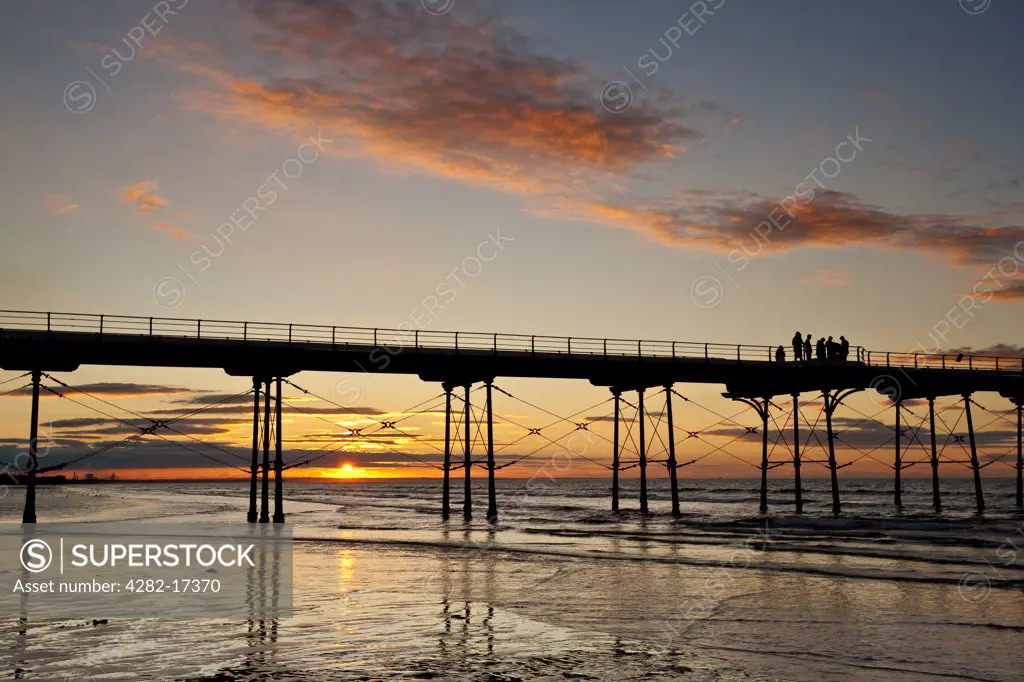 England, Redcar & Cleveland, Saltburn-By-The-Sea. Sunset over the Victorian pier at Saltburn-By-The-Sea, the first and last on the North East coast.