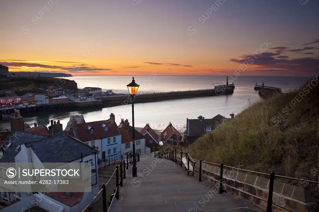 England, North Yorkshire, Whitby. View from Whitby's 199 steps over the harbour at sunset.